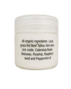 A white plastic jar with a ribbed screw-top lid, featuring black text on the front listing organic ingredients including beef tallow, zinc oxide, calendula, beeswax, rosehip, raspberry seed, and peppermint oil.
