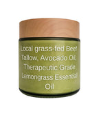 A jar of Lemongrass Essential Oil with a light wood-grain lid and a green label containing white text, set against a plain white background.