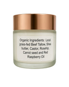 A glass jar of organic beef tallow skincare cream with a metallic rose gold lid and a white label detailing the ingredients.