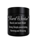 Black Muscle/Joint Relief balm jar with ingredient label on a transparent background.