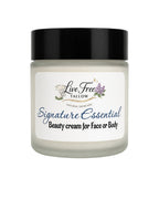 A jar of Live Free Tallow Signature Essential Beauty cream for face or body, featuring a black lid and a white label with blue and black text.