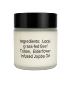 A frosted glass jar of beef tallow skincare cream with a black lid, featuring black text on the front detailing the ingredients.